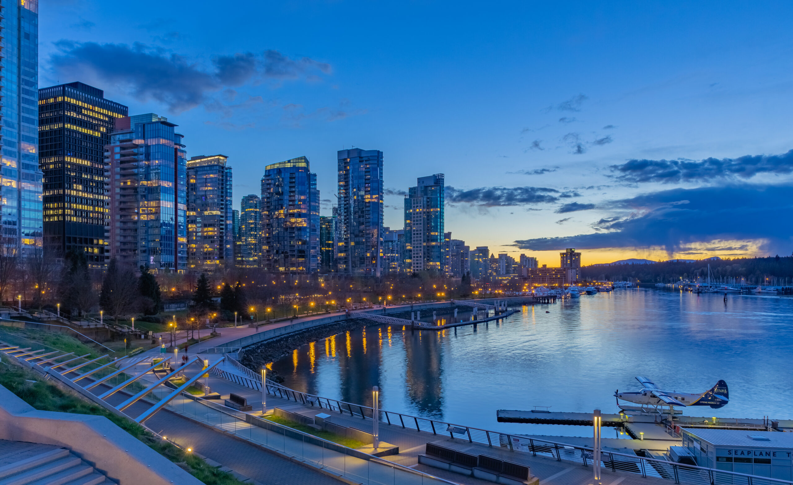 Coal Harbour night scene of modern buildings in Vancouver downtown. Long exposure of waterfront in Vancouver. Colorful city night with skyscrapers. Street photo, selective focus, night photo